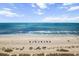 Expansive sandy beach with blue ocean waves, beach umbrellas, and distant figures under a partly cloudy sky at 2401 S Ocean Blvd. # 1262, Myrtle Beach, SC 29577