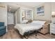 Bedroom featuring a pull-out sofa bed, full-length mirror, and neutral decor, offering a versatile space for guests at 2401 S Ocean Blvd. # 1262, Myrtle Beach, SC 29577