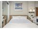 Bedroom featuring a cozy bed with white linens and a beach-themed artwork, promoting relaxation at 2401 S Ocean Blvd. # 1262, Myrtle Beach, SC 29577