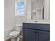 Bathroom features a sleek vanity with a stylish blue base cabinet and a window at 250 Six Mile Creek Dr., Georgetown, SC 29440