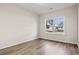 Bright, neutral bedroom featuring hardwood floors and a large window at 250 Six Mile Creek Dr., Georgetown, SC 29440