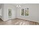 Bright dining room with a chandelier and a glass door leading to the outdoor space at 250 Six Mile Creek Dr., Georgetown, SC 29440