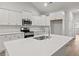 Well-equipped kitchen featuring stainless steel appliances, white cabinets, and a quartz countertop island at 250 Six Mile Creek Dr., Georgetown, SC 29440