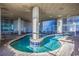 Indoor lazy river style pool with blue tiles, large windows, and brick floors at 2504 N Ocean Blvd. # 1730, Myrtle Beach, SC 29577