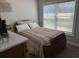 Bedroom with a bed by a bright window and a traditional-style nightstand at 2594 W Shore Dr., Longs, SC 29568