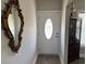 Foyer with decorative mirror, chandelier, and paneled front door with decorative stained glass at 2594 W Shore Dr., Longs, SC 29568