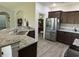 Beautiful kitchen with stainless steel refrigerator, granite countertops and access to dining room at 2594 W Shore Dr., Longs, SC 29568