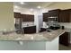 Modern kitchen featuring granite countertops, stainless steel appliances, and dark brown cabinets at 2594 W Shore Dr., Longs, SC 29568