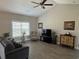 Bright living room featuring a ceiling fan, hardwood floors, and a large window for natural light at 2594 W Shore Dr., Longs, SC 29568