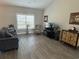 Comfortable living room with hardwood floors, a ceiling fan, and a large window for natural light at 2594 W Shore Dr., Longs, SC 29568