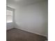 An empty bedroom with neutral carpeting, a window with blinds, and freshly painted white walls at 2681 Ophelia Way, Myrtle Beach, SC 29577
