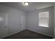 An empty bedroom featuring neutral carpeting, a window with blinds, and white trim at 2681 Ophelia Way, Myrtle Beach, SC 29577