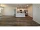 Open-concept living room and kitchen area with hardwood floors and bright, natural light at 2681 Ophelia Way, Myrtle Beach, SC 29577