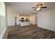 Spacious living room adjacent to kitchen with wood floors and a modern ceiling fan at 2681 Ophelia Way, Myrtle Beach, SC 29577