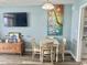 Cozy dining area with TV, chest, and colorful art at 2801 S Ocean Blvd. # 1535, North Myrtle Beach, SC 29582