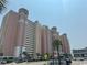 Large beachside condominium with palm trees, parking, and pedestrian crossing at 2801 S Ocean Blvd. # 1535, North Myrtle Beach, SC 29582
