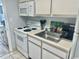 Efficient kitchen features white appliances, ample counter space, and essential cookware at 2801 S Ocean Blvd. # 1535, North Myrtle Beach, SC 29582