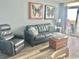 Living room with ocean view, sofa, recliner, and butterfly artwork at 2801 S Ocean Blvd. # 1535, North Myrtle Beach, SC 29582