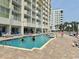 Outdoor swimming pool with sunbathers at condo community with beach access at 2801 S Ocean Blvd. # 1535, North Myrtle Beach, SC 29582