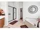 Bright bathroom featuring a soaking tub, a glass-enclosed shower and a decorative mirror at 2818 Sanctuary Blvd., Conway, SC 29526