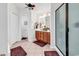 Well-lit bathroom features double vanity and glass shower, offering a functional and stylish space, easy to clean at 2818 Sanctuary Blvd., Conway, SC 29526