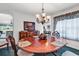 Formal dining room with a wooden table, elegant chandelier, and classic decor at 2818 Sanctuary Blvd., Conway, SC 29526