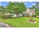 Well-maintained home with lush lawn, large shade tree, and neatly landscaped flower beds at 2818 Sanctuary Blvd., Conway, SC 29526