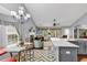 Open living area features cathedral ceiling, fireplace, many windows, and kitchen view, perfect for modern living at 2818 Sanctuary Blvd., Conway, SC 29526