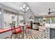 Open-concept living area with cathedral ceiling, fireplace, bay window and view to kitchen, creating a stylish and inviting space at 2818 Sanctuary Blvd., Conway, SC 29526