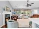 Comfortable living room with fireplace and many windows, creating a warm and inviting atmosphere with modern ceiling fan at 2818 Sanctuary Blvd., Conway, SC 29526