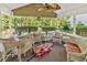 Inviting screened porch with wicker furniture, a ceiling fan, and views of the lush, green outdoor space at 2818 Sanctuary Blvd., Conway, SC 29526