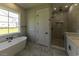Beautiful bathroom featuring a soaking tub under a window and tiled walk-in shower at 287 West Palms Dr., Myrtle Beach, SC 29579