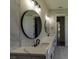 Bathroom boasts dual sinks, modern fixtures, and elegant round mirrors at 287 West Palms Dr., Myrtle Beach, SC 29579
