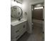 Elegant bathroom featuring a tub, shower, and modern vanity with a round mirror at 287 West Palms Dr., Myrtle Beach, SC 29579