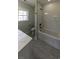 Well-lit bathroom with a tub-shower combo and a gray tile surround at 287 West Palms Dr., Myrtle Beach, SC 29579