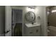 Well-lit bathroom featuring a modern vanity, updated fixtures, and tiled bath at 287 West Palms Dr., Myrtle Beach, SC 29579