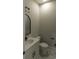 Modern half bath with marble floors, white vanity, black fixtures, and round mirror at 287 West Palms Dr., Myrtle Beach, SC 29579
