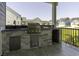Outdoor kitchen with tile backsplash, grill, cabinets, and granite countertop at 287 West Palms Dr., Myrtle Beach, SC 29579