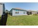 Exterior view of the home featuring a lush lawn, patio, and black fence, perfect for outdoor living at 2979 Skylark Dr., Myrtle Beach, SC 29577