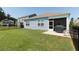 Backyard featuring lush grass, a screened porch with a grill, and secure fencing, ideal for outdoor enjoyment at 2979 Skylark Dr., Myrtle Beach, SC 29577