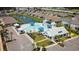 Aerial view of a luxurious community pool with a splash pad, sun loungers, and ample parking at 2979 Skylark Dr., Myrtle Beach, SC 29577