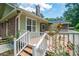 An elevated view of the wooden back deck with white railings and a house with a chimney at 309 Otter Run Rd., Pawleys Island, SC 29585