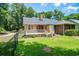Back exterior featuring a wooden deck overlooking a private backyard at 309 Otter Run Rd., Pawleys Island, SC 29585