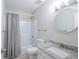 Clean bathroom with a granite countertop sink and a shower with gray and white curtains at 309 Otter Run Rd., Pawleys Island, SC 29585