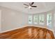 Large bedroom features a tray ceiling, hardwood floors, and three large windows at 309 Otter Run Rd., Pawleys Island, SC 29585