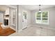 Dining area featuring a modern light fixture, views of the outside, and access to the kitchen and living room at 309 Otter Run Rd., Pawleys Island, SC 29585