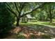 Exterior view of home, surrounded by mature trees and a well-maintained lawn at 309 Otter Run Rd., Pawleys Island, SC 29585