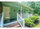 Charming home with a covered front porch, brick stairs, and neatly landscaped yard at 309 Otter Run Rd., Pawleys Island, SC 29585