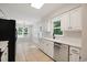 Renovated kitchen featuring stainless steel appliances and views into the dining area at 309 Otter Run Rd., Pawleys Island, SC 29585