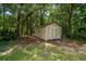Exterior shot of storage shed featuring double doors in backyard with trees at 309 Otter Run Rd., Pawleys Island, SC 29585